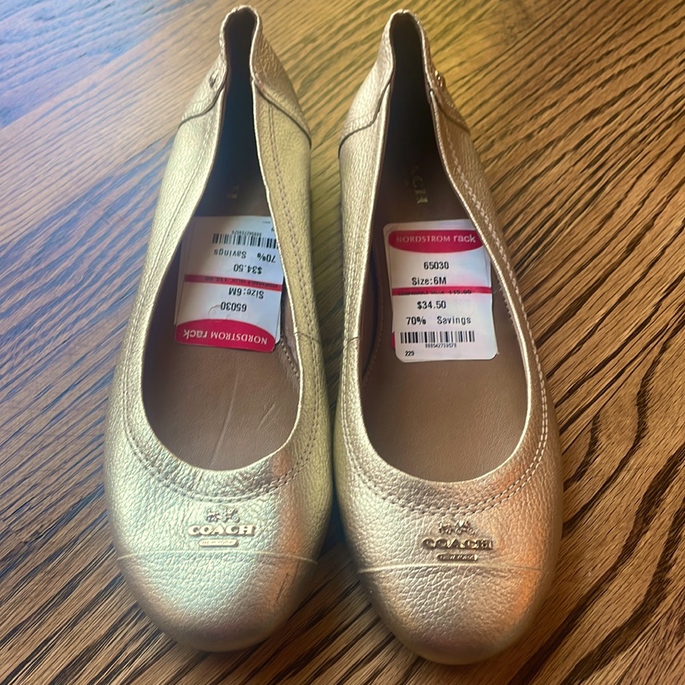 Coach gold slip-ons